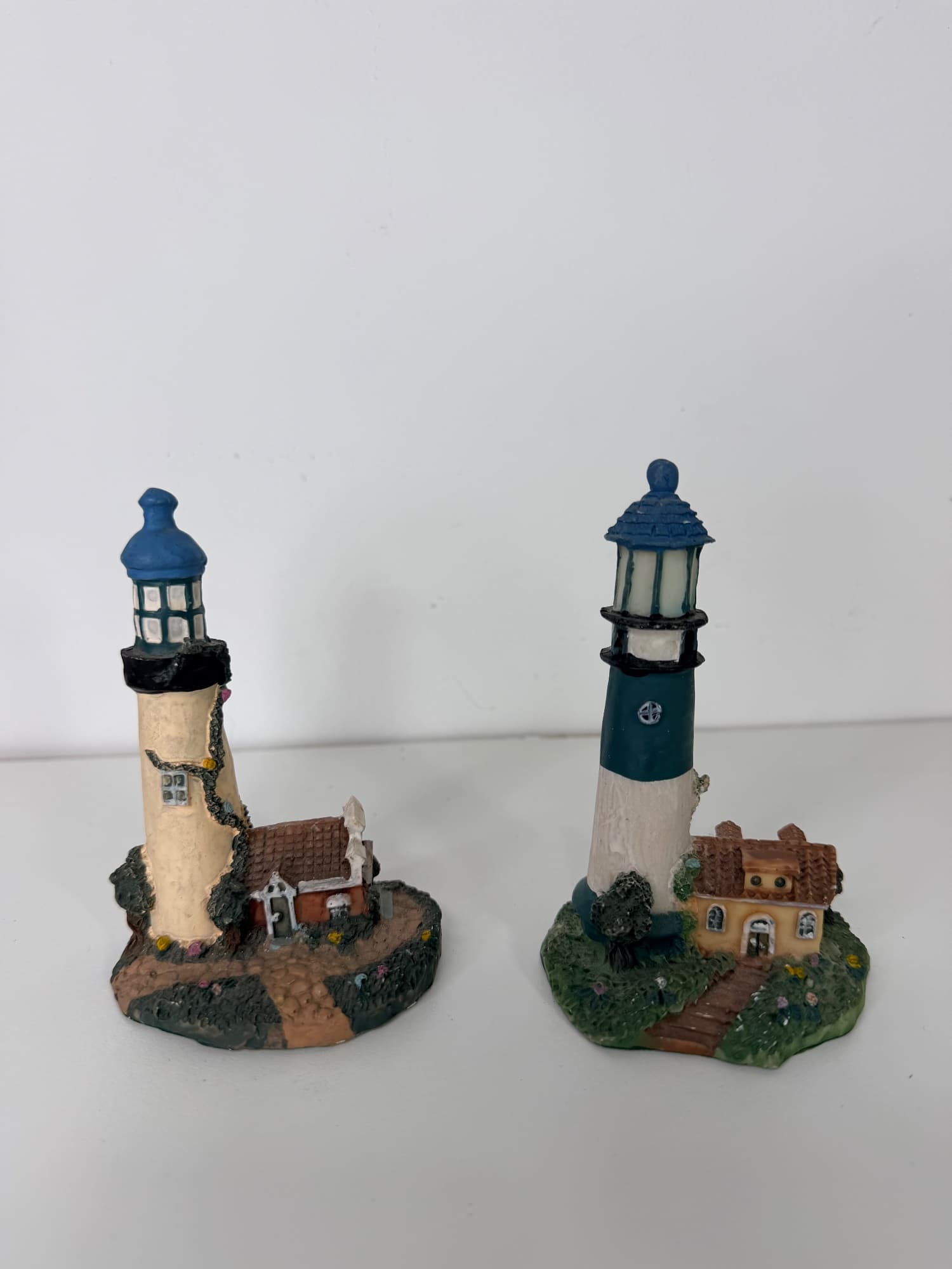 Set of 2 resin lighthouse figurines with cottage base